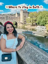 A travel influencer poses in front of the Pulteney Bridge in Bath, promoting a stay at Dukes Hotel.