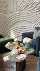 A short, polished video showcasing a new croissant concept at Pavyllon London within the Four Seasons Hotel. The video features close-up shots of various sweet and savoury croissants, including ice cream-filled options and a lamb-filled croissant, alongside a matcha latte, set against the elegant backdrop of the hotel's interior.