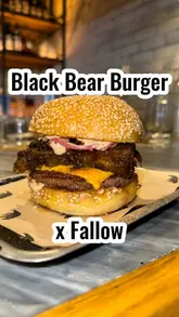 A creator reviews a limited-edition collaboration burger between Black Bear Burger and Fallow, highlighting the ingredients and taste profile.