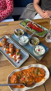 A montage showcasing a variety of Greek meze dishes and cocktails at Simply Greek in Edinburgh, highlighting the food presentation and interior decor.
