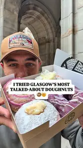 A creator visits Tantrum Doughnuts in Glasgow, showcasing the shop's display and tasting four different doughnut varieties: Pistachio & Hibiscus, Blueberry & White Chocolate, Brazilian Lemonade, and Tropical Curd. The video is a fast-paced, enthusiastic review that highlights the quality and variety of the doughnuts.