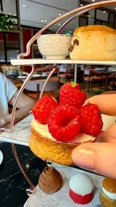 A short, polished video showcasing an afternoon tea service at The Lowry Hotel in Manchester, featuring close-ups of the savoury and sweet tiers, the tea service, and the venue's interior.