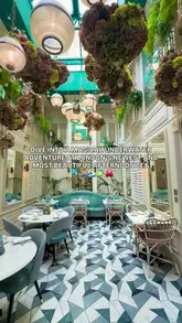 A promotional video showcasing an underwater-themed afternoon tea experience at 100 Queen's Gate Hotel in London, featuring sea-life inspired sweet and savoury treats in a botanical conservatory setting.