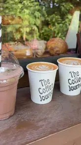 A short montage video showcasing The Coffee Journey, a converted horsebox coffee van. The video features close-ups of latte art being poured, iced drinks, and various pastries like cruffins and turnovers, set to music.