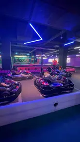 A fast-paced montage showcasing the various entertainment facilities at the new Hollywood Bowl in Cardiff, including bowling, go-karting, arcade games, and pool, alongside casual dining options.