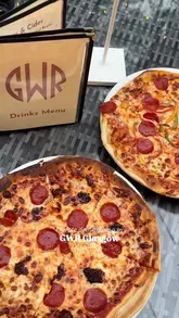 The video features a visit to GWR in Glasgow, highlighting their private dining domes. It shows the creator enjoying the space, ordering various dishes including salt and chilli chicken, haggis bonbons, and wood-fired pizzas, as well as dessert cocktails.
