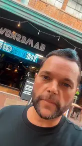 A creator visits GamesRow in Worthing, providing a tour of the arcade games, pool tables, and darts area, followed by a showcase of the food menu, including burgers, pizzas, and mac and cheese.