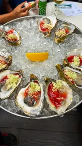 A promotional reel for The Finnieston featuring a new menu launch, focusing on a variety of oysters with unique toppings and signature cocktails. The video includes shots of the food preparation, the finished dishes, and the drinks, along with commentary from the staff.