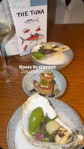 A montage showcasing a 10-course tasting menu experience at a restaurant, featuring close-ups of various dishes, wine pairings, and the restaurant's atmosphere.