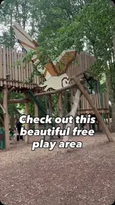 A short, handheld video tour of a woodland-themed playground, showcasing the various climbing structures, slides, and play equipment available for children.