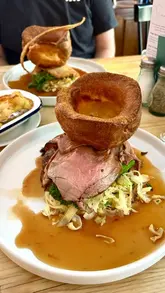 A review video of The Bell Inn at Ladbroke, showcasing the interior, Sunday roast menu, various dishes including starters, mains, and desserts, and the exterior of the pub.