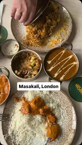 A promotional video for Masakali, an Indian restaurant, showcasing the interior, cocktail preparation, and a variety of dishes including samosa chat, chicken lollipop, dal makhani, butter chicken, lamb biryani, and gulab jamun churros.