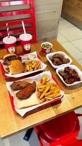 A fast-paced promotional video for Dave's Hot Chicken featuring close-ups of their chicken tenders, sliders, saucy bites, and loaded fries. The video uses quick cuts and upbeat music to showcase the menu variety and food textures, including a brief look at the ordering kiosk and drink station.