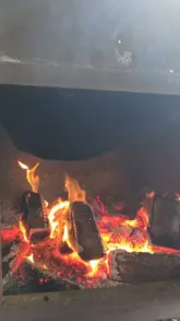 A short video showcasing a BBQ smoking class at a venue called Smoke in Carryduff. The footage focuses on the smoking process, showing various cuts of meat like ribs, chicken, and pork belly being prepared and cooked in a large smoker.