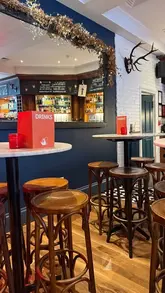 A creator visits The Red Squirrel in Edinburgh for a brunch review. She tours the interior, shows the menu, and reviews an iced caramel latte, a ham and cheese croissant, and a kids' breakfast.
