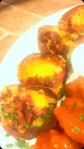 A promotional video for TGI Fridays at the Metrocentre, showcasing the interior, cocktails, and various menu items like potato skins, buffalo wings, and a burger.