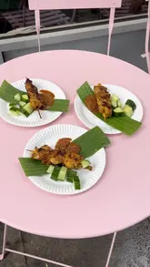 A short, energetic video documenting a satay pop-up event hosted at a local butcher shop. The video features the cooking process, the setup, and customers enjoying the food despite the rainy weather.