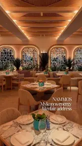 A polished, aesthetic showcase of Nammos London, highlighting the upscale interior design and high-end food presentation.