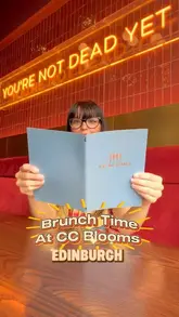 A short review reel featuring a creator visiting CC Blooms in Edinburgh for brunch, showcasing cocktails and brunch dishes like berry waffles and scrambled eggs royal.