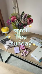 A day-in-the-life vlog following a couple on a scroll-free Sunday in London. The video documents a series of activities including playing padel, visiting a coffee shop, shopping for furniture, unboxing phone cases, having dinner at a Mediterranean restaurant, and watching a play at Shakespeare's Globe.