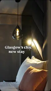 A video showcasing a stay at The Wellington hotel in Glasgow, highlighting the room's interior, amenities like the kitchenette and rainfall shower, and the overall relaxing atmosphere.