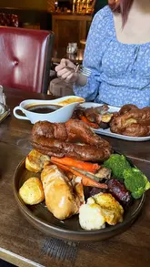 A short, cozy video showcasing a Sunday roast at The Royal Oak, featuring close-ups of the food and shots of the pub's interior and exterior.
