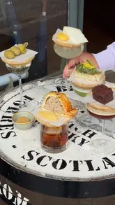 A short, aesthetic montage showcasing a 'cocktails and picky bits' pairing menu at Arch 13 in Birmingham's Jewellery Quarter, featuring various cocktails paired with small snacks.
