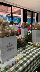 The video provides a tour of a festive hospitality event at the Principality Stadium in Cardiff. It highlights the stadium views, the private suite setup, the festive food spread including sliders and pigs in blankets, and an interactive candle-painting activity.