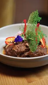 A high-quality, visually focused food showcase of Toba, an Indonesian restaurant in London, featuring close-up shots of various dishes like satay, rendang, and desserts.