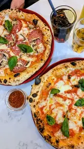 A short, energetic promotional reel for Spaccanapoli in Glasgow, showcasing their Neapolitan pizzas, the restaurant exterior, and the pizza-making process.