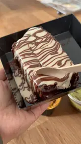 A short video showcasing three different dessert slices: a chocolate cake, a kunafa cake, and a Biscoff milk cake. The creator uses a wooden spoon to scoop and pull apart the desserts to show their texture.