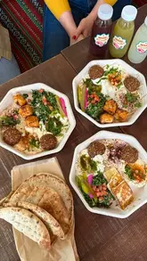 A short video showcasing a lunch mezze box at Comptoir Libanais, featuring halloumi, falafel, hummus, and salad, followed by a brief tour of the restaurant's colourful interior.