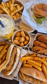 A short, straightforward video showcasing a visit to a Chicken Shop, featuring shots of the exterior, interior, and a spread of fried chicken, burgers, and fries.
