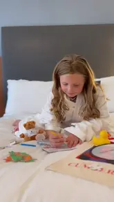 A vlog-style video featuring a young girl and her companion staying at The Cumberland Hotel in London, showcasing the hotel's music-themed decor, comfortable rooms, and dining options.
