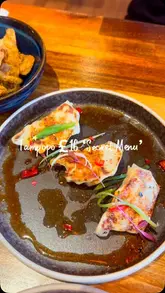 A creator visits Tampopo to showcase their 'secret menu' deal, which offers a starter, main, and drink for £16. The video features close-ups of various dishes like dumplings, spring rolls, pork belly, and pad thai, interspersed with the creator trying the food and explaining the deal.