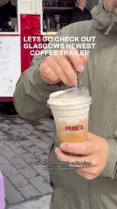 A vlog-style review of a new coffee trailer in Glasgow called Phil's, located near the Barclays building. The creators introduce the spot, show the trailer, and perform a taste test of their brown sugar shaken espresso with oat milk and vanilla cold foam.