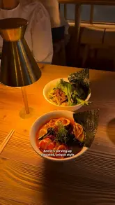 A review of Nakimushi, a new Japanese restaurant in Notting Hill, showcasing its cozy, intimate interior, open kitchen, and a variety of dishes including ramen, sashimi, gyoza, and chicken karaage.