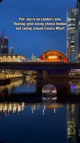A visually appealing video showcasing a unique dining experience in London where guests eat cheese fondue inside floating igloos while sailing around Canary Wharf at night.