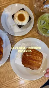 A short, aesthetic reel showcasing a variety of Japanese-inspired pastries and drinks at a newly opened cafe near Euston. The video features close-up shots of items like a salted bun, chocolate miso cake, and a lemongrass curry chicken pain suisse, emphasizing the unique flavor profiles.