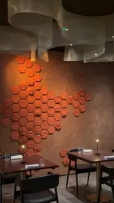 A montage of high-end, creative Indian dishes and the sophisticated interior of a fine dining restaurant. The video features close-up shots of intricate plating, dry ice effects, and the chef's final touches, emphasizing the premium nature of the establishment.