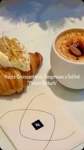 A polished, high-end promotional reel showcasing a collaboration between Sofitel and Nespresso, featuring artisanal croissants and coffee pairings within a luxury hotel suite setting.