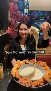 A short video showcasing a Korean restaurant in London, highlighting a cheesy fried chicken platter, sushi rolls, and a Korean pancake, along with promotional offers.