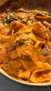 A home cooking tutorial video where the creator demonstrates how to make a 'Marry Me Butter Bean Lasagne' as part of a budget-friendly meal series. The video features the creator preparing the dish step-by-step, with clear instructions and appetizing shots of the final result.