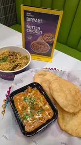 A promotional video for Naan Staap in Leicester, showcasing their new menu items including Butter Chicken and Biryani, alongside existing favorites like Lamb Qeema Masala Naan, Gol Gappa, and Karak Chai. The video highlights the restaurant's colorful, culturally-inspired interior decor and provides a close-up look at the food presentation.