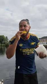 A creator reviews Jamaican street food from a takeaway spot in Staines, testing the quality of the jerk chicken, curry goat, and patties while providing commentary on the local area.
