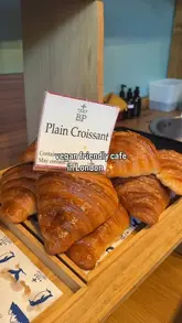 A vlog-style review of a vegan-friendly bakery and cafe in London, showcasing a variety of pastries, coffee, and the cozy interior.