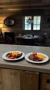 A short, aesthetic montage showcasing a cosy autumn staycation at a lodge, featuring scenes of a bathtub, a fireplace, a bedroom, and a breakfast spread.