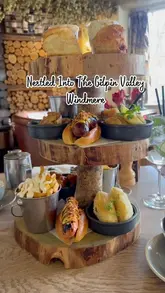 A short, atmospheric video showcasing an afternoon tea service at The Wild Boar Estate in the Lake District, featuring close-ups of the food and the cozy fireplace setting.