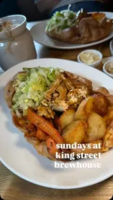 A short video featuring a person enjoying a Sunday roast at King Street Brewhouse in Cambridge, highlighting the generous portion size and value.