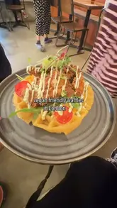 A short-form video review of Utter Waffle in London, featuring a variety of vegan and gluten-free brunch dishes including fried chick'n waffles, loaded hash stack, and French toast. The video highlights the cosy interior, the dog-friendly policy, and the overall dining experience.